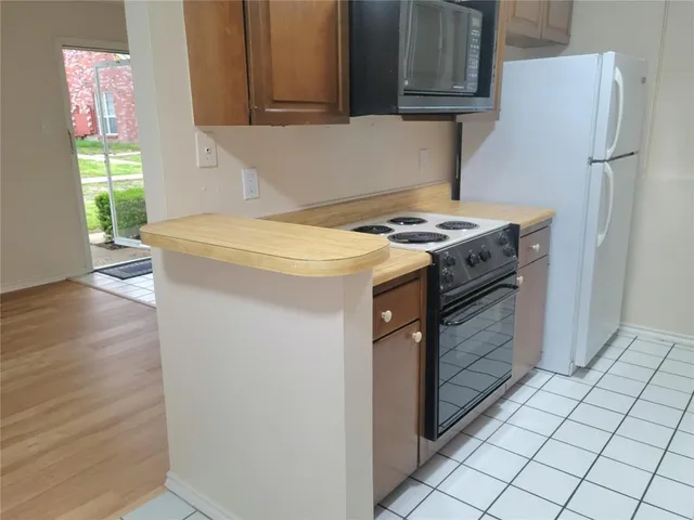 a kitchen with a stove top oven and cabinets