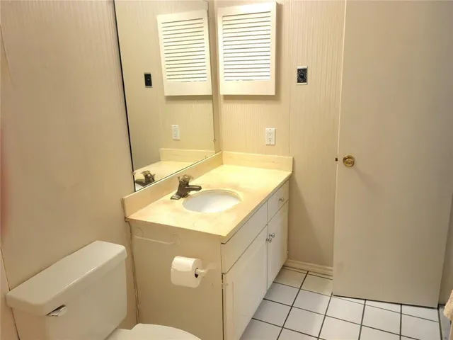 a bathroom with a sink toilet and vanity