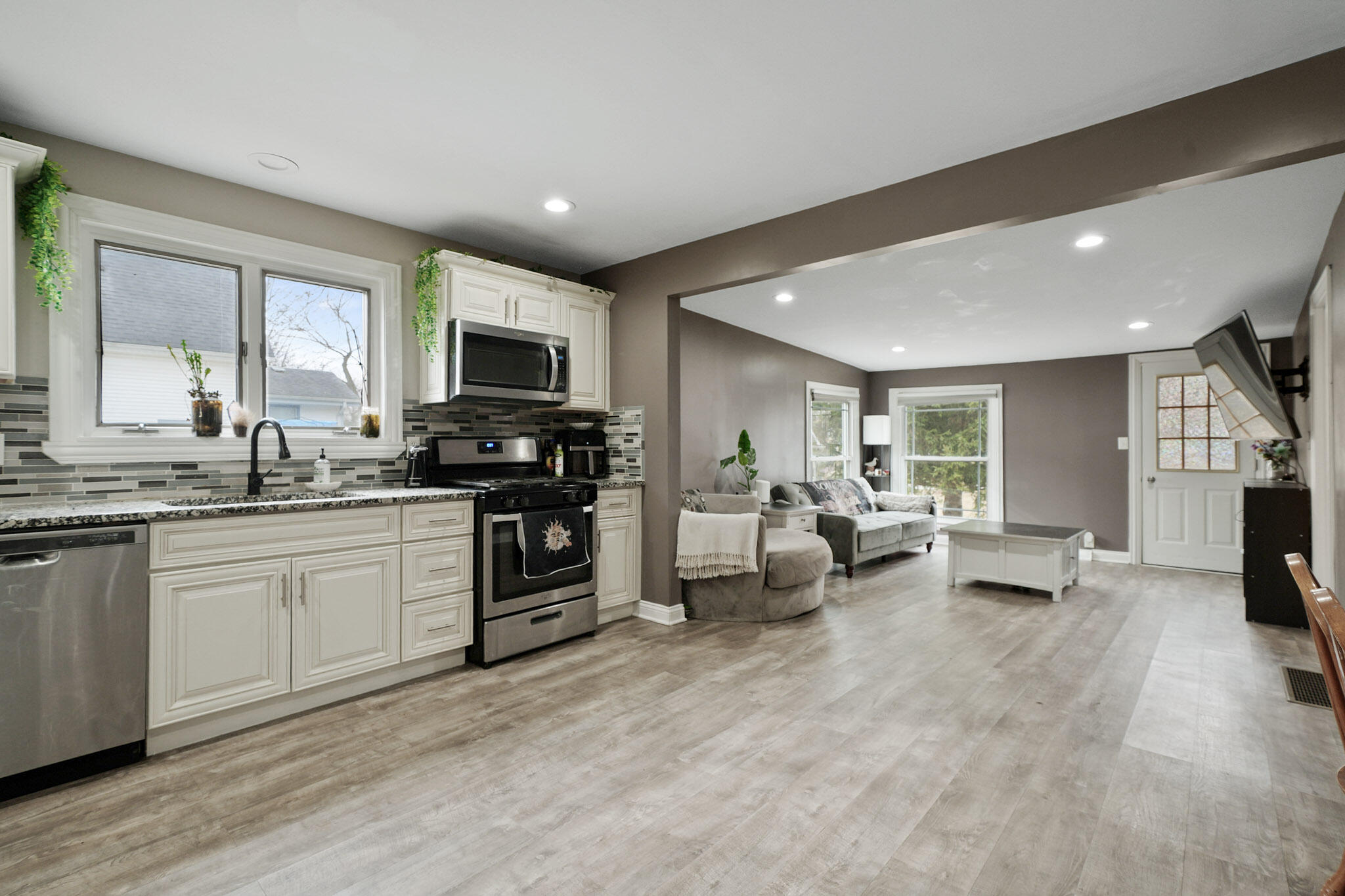 345 Castle Street Lowell, IN 46356 - Photo 19 of 27 a kitchen with granite countertop a stove a sink and a refrigerator