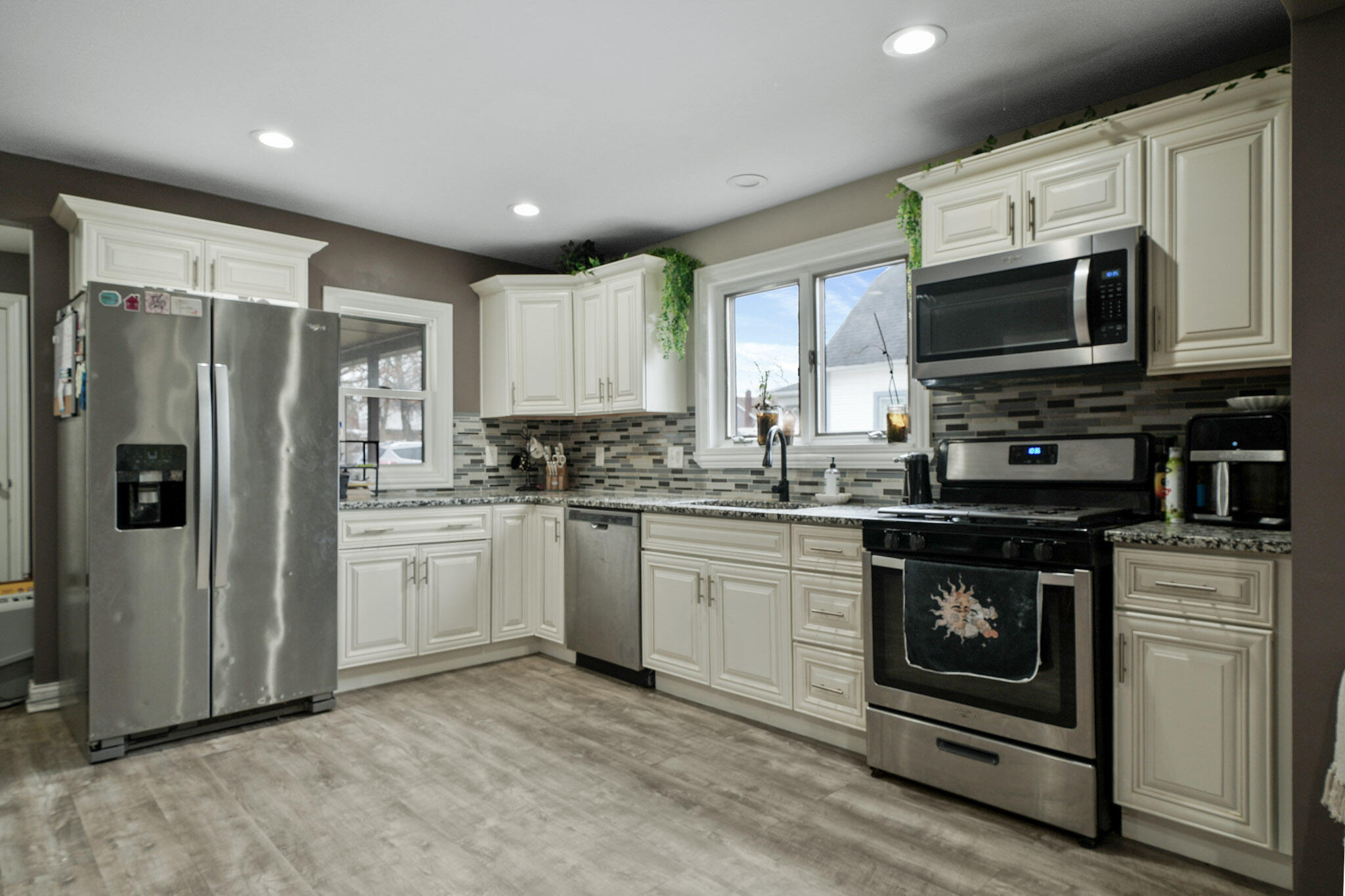345 Castle Street Lowell, IN 46356 - Photo 21 of 27 a kitchen with stainless steel appliances granite countertop a stove a refrigerator and a microwave