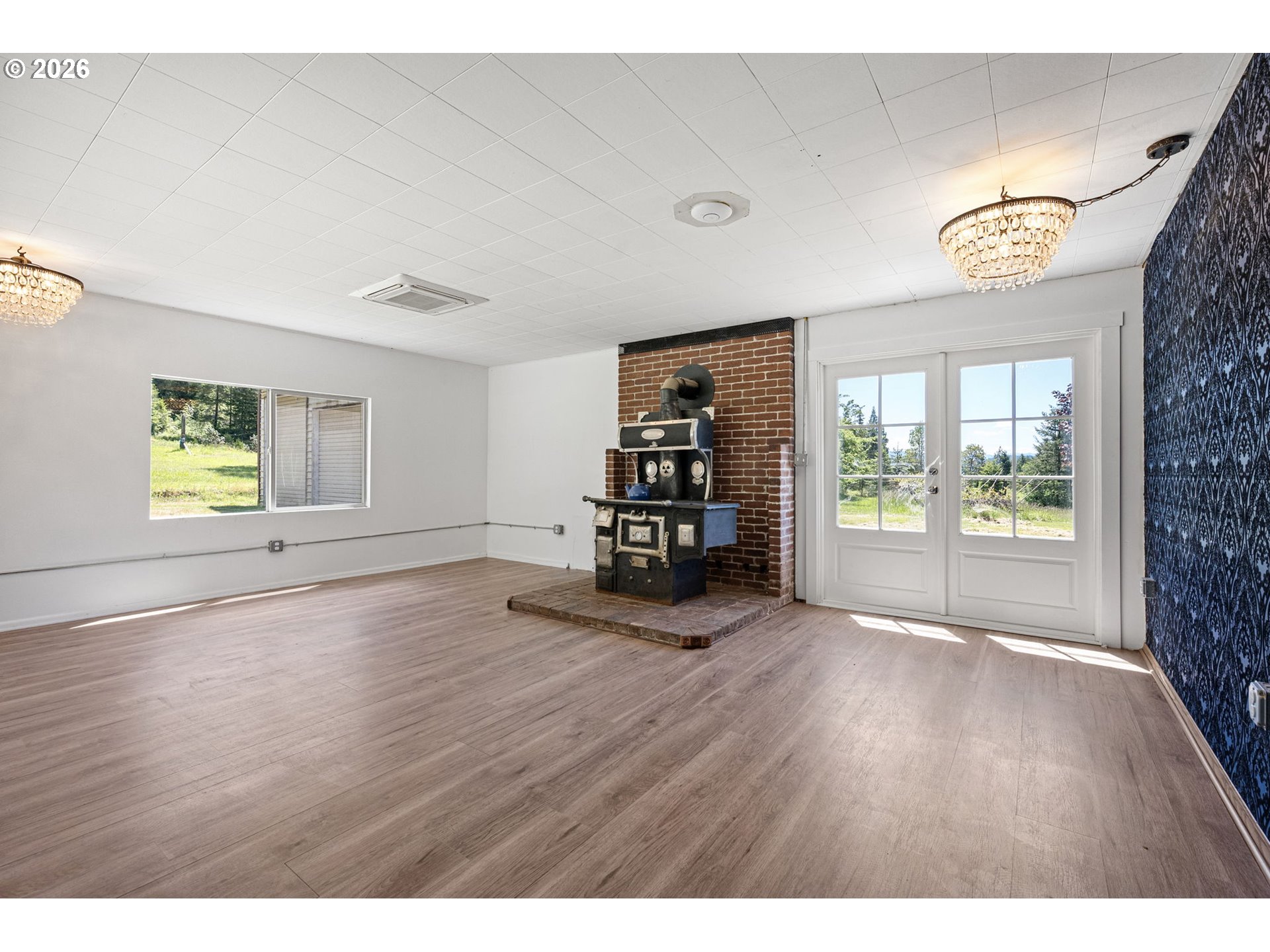 77521 Brock Road Oakridge, OR 97463 - Photo 6 of 48 a view of an empty room with a window and wooden floor