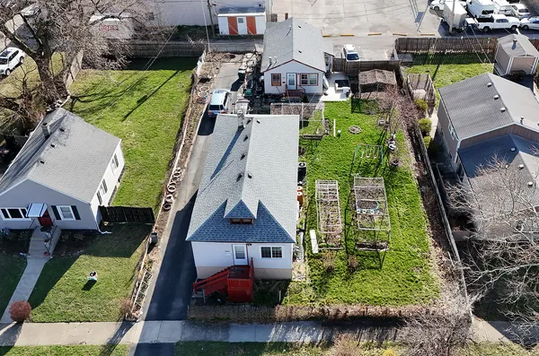 an aerial view of multiple houses with yard