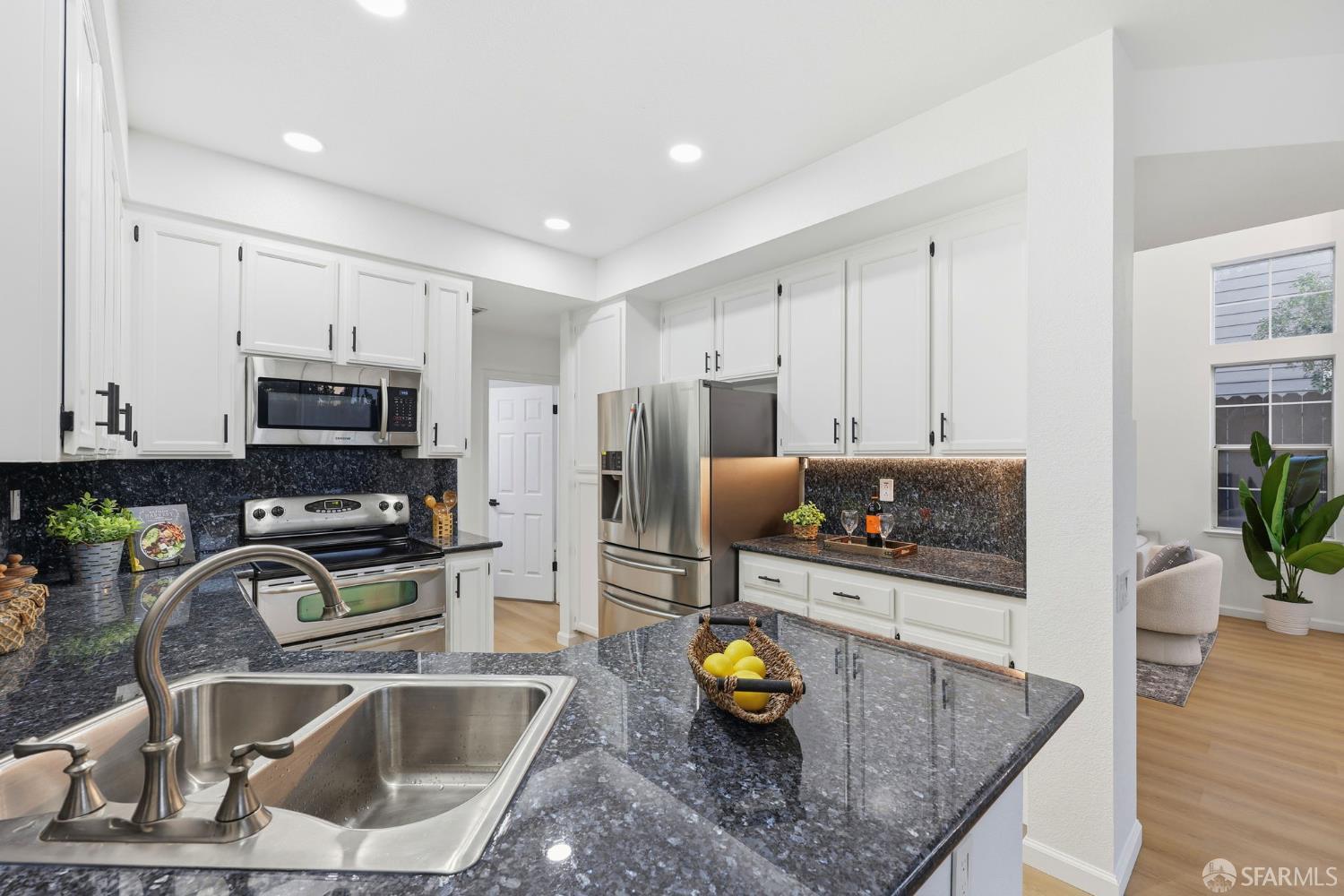 287 Scotts Valley Hercules, CA 94547 - Photo 13 of 42 a kitchen with a sink a counter and chairs