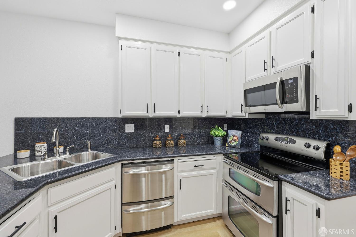 287 Scotts Valley Hercules, CA 94547 - Photo 15 of 42 a kitchen with stainless steel appliances granite countertop a sink a stove and a microwave