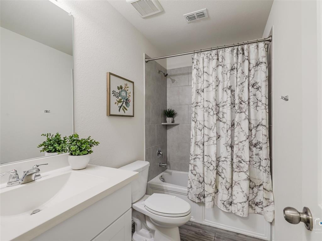 4517 Ashmark Road Aubrey, TX 76227 - Photo 7 of 26 a bathroom with a sink toilet and shower