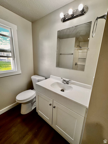 158 Cushing Way Layton, UT 84041 - Photo 9 of 14 Bathroom featuring a white vanity with integrated sink, chrome faucet, and a large wall-mounted mirror