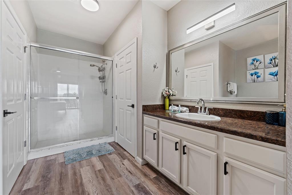 14200 Avalon Road, Unit 409 Winter Garden, FL 34787 - Photo 18 of 33 a bathroom with a granite countertop sink mirror and shower