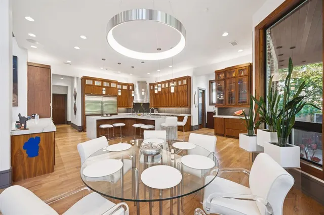 a dining room with furniture a table and kitchen view