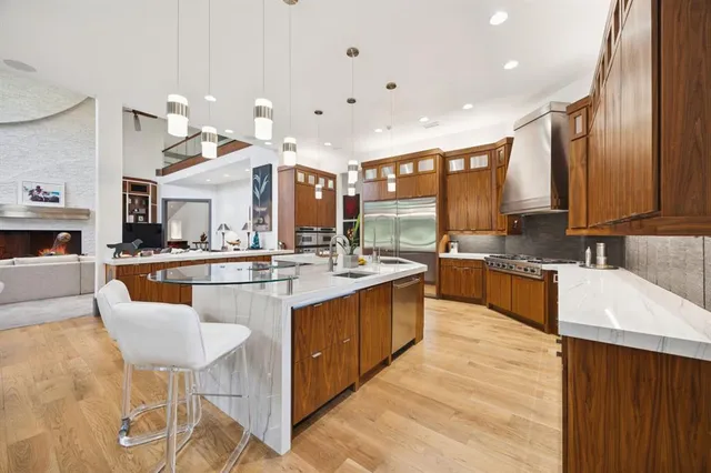 a large kitchen with a large counter top appliances and cabinets