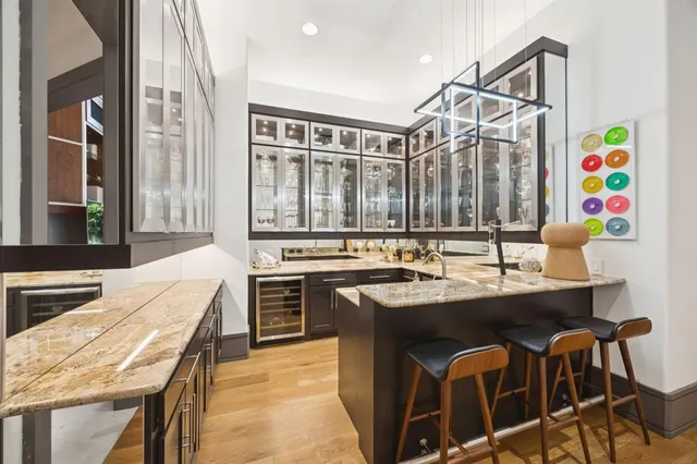 a kitchen with a sink a stove and chairs