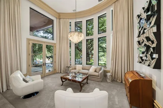 a living room with furniture and a chandelier