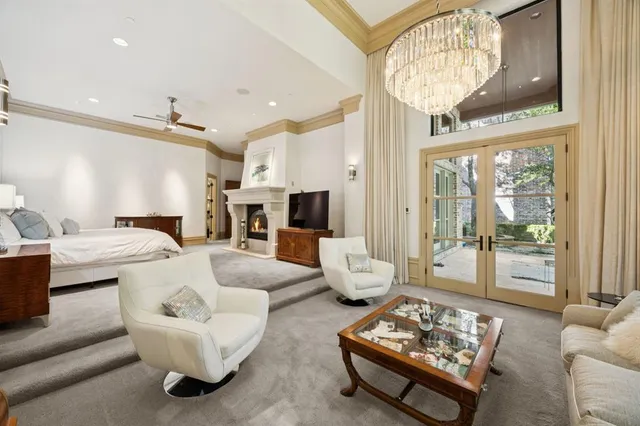 a spacious bedroom with a large bed and a fireplace