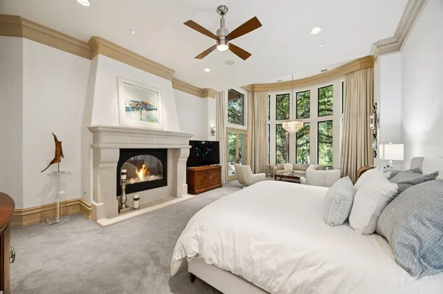 a large spacious bathroom with a tub a double vanity sink and glass door