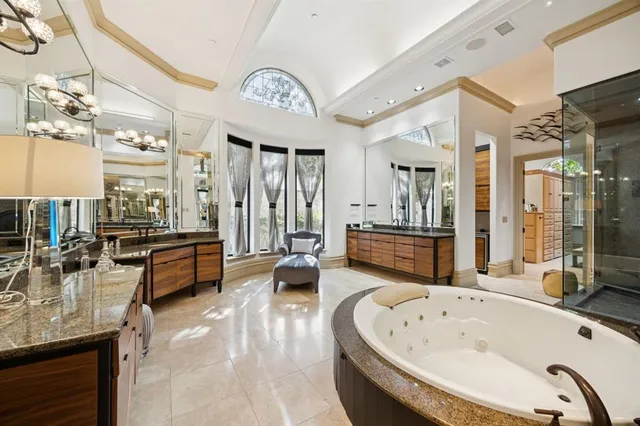 a large spacious bathroom with a large tub and shower