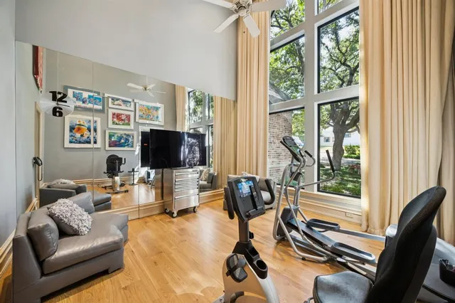 a kitchen with granite countertop a white refrigerator a stove and white cabinets with wooden floor