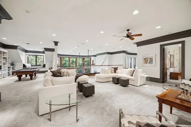 a bedroom with a bed lamp and a large window