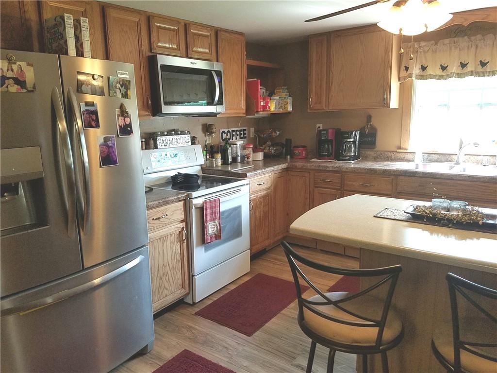402 Levine Lane Ruffs Dale, PA 15679 - Photo 8 of 22 a kitchen with stainless steel appliances granite countertop a refrigerator a stove a sink and a microwave