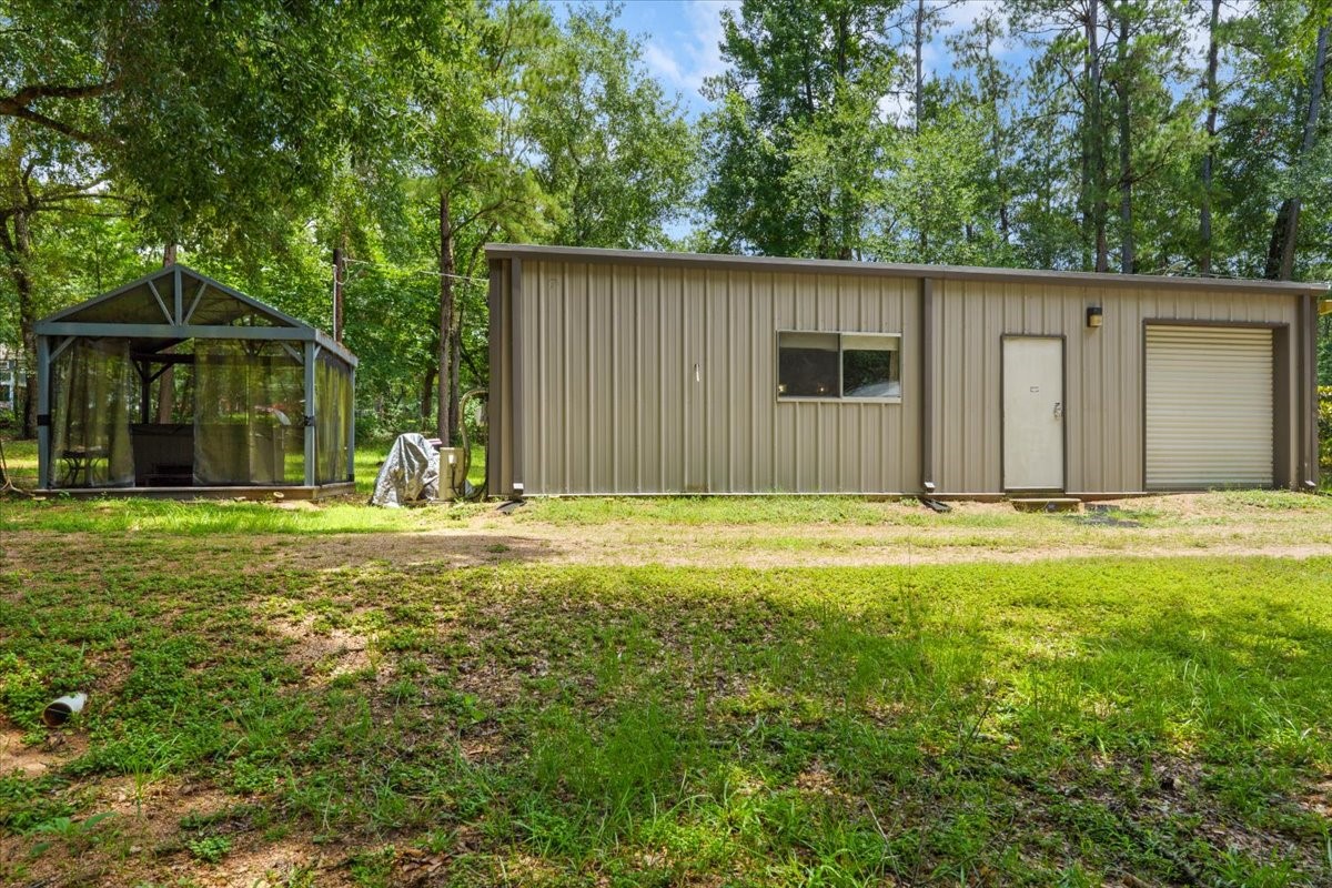 16375 Grand Flower Road Plantersville, TX 77363 - Photo 19 of 50 a house view with swimming pool in front of it