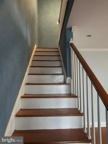 a view of a hallway view with wooden floor and staircase