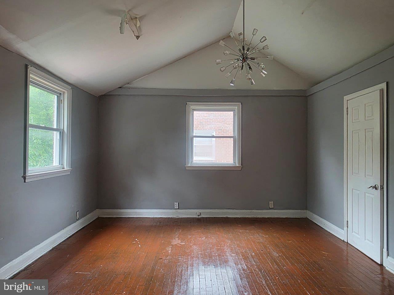 2211 Echodale Avenue Baltimore, MD 21214 - Photo 13 of 30 wooden floor in an empty room with a window