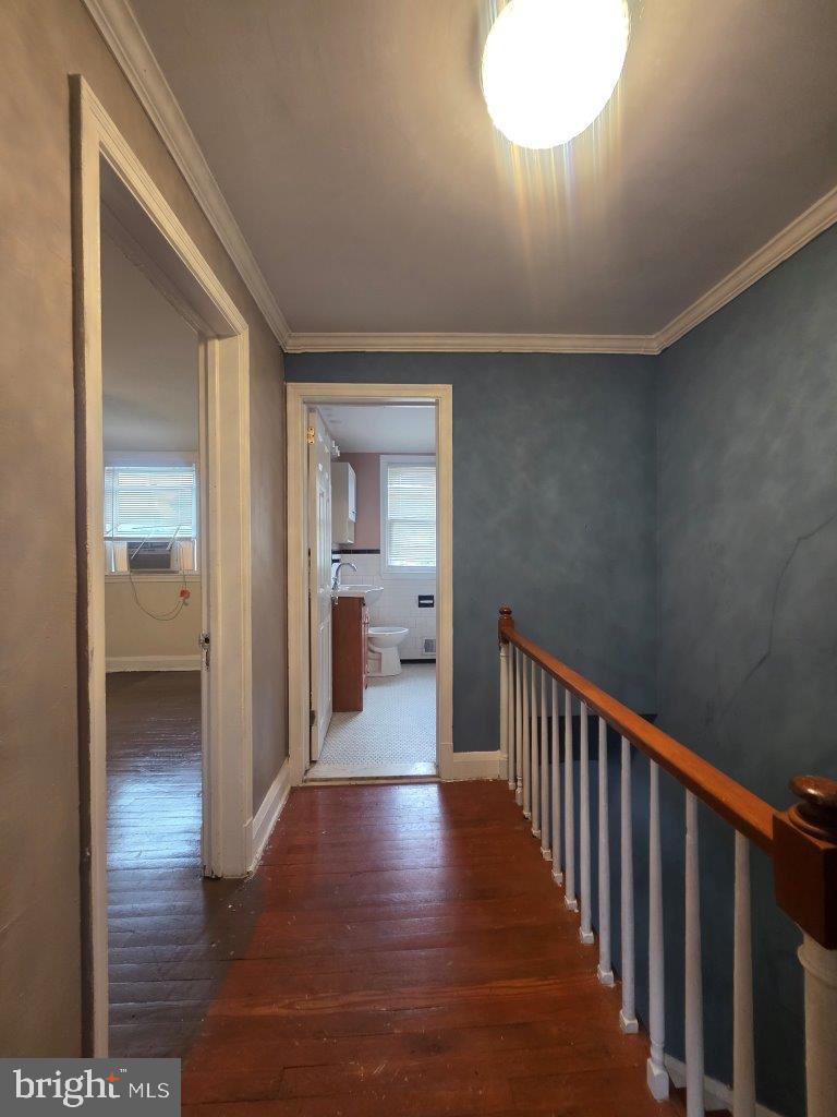 2211 Echodale Avenue Baltimore, MD 21214 - Photo 16 of 30 a view of a hallway view with wooden floor and a bathroom
