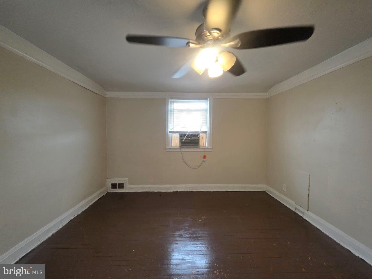 2211 Echodale Avenue Baltimore, MD 21214 - Photo 18 of 30 an empty room with wooden floor and windows