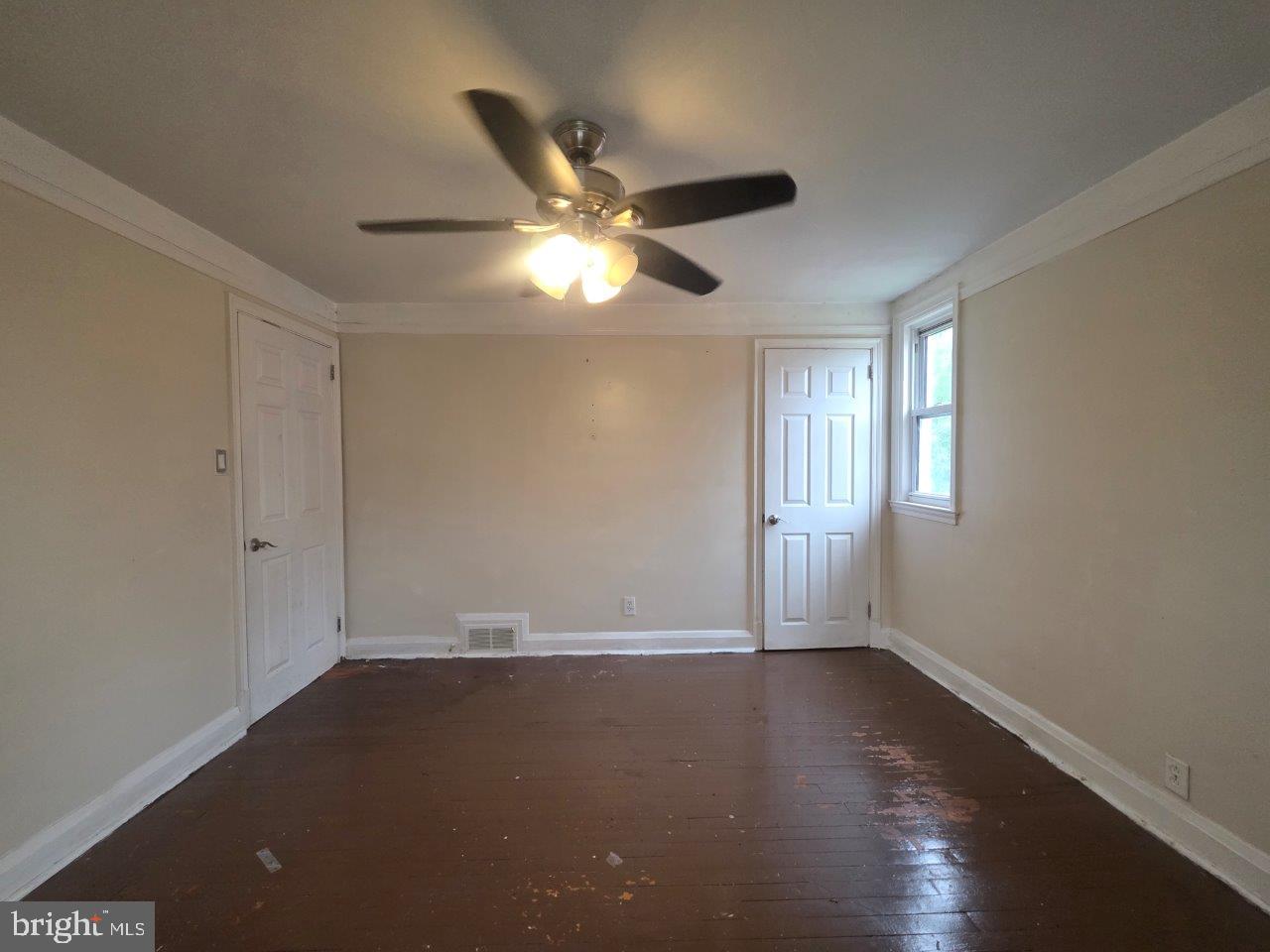 2211 Echodale Avenue Baltimore, MD 21214 - Photo 19 of 30 a view of an empty room with window and wooden floor