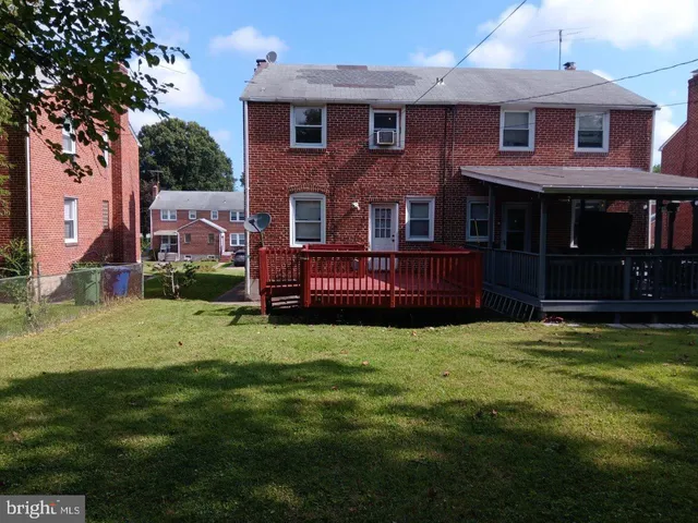 a view of a house with a wooden fence