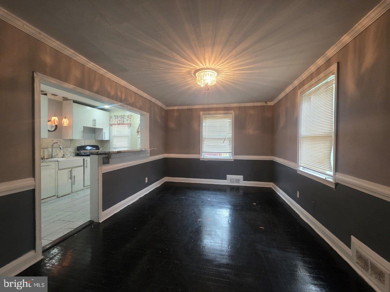 2211 Echodale Avenue Baltimore, MD 21214 - Photo 7 of 30 a view of an empty room with a window and wooden floor