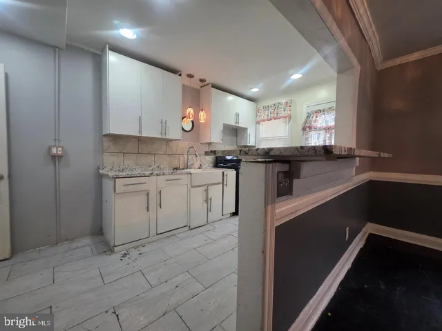 a kitchen with a sink and refrigerator