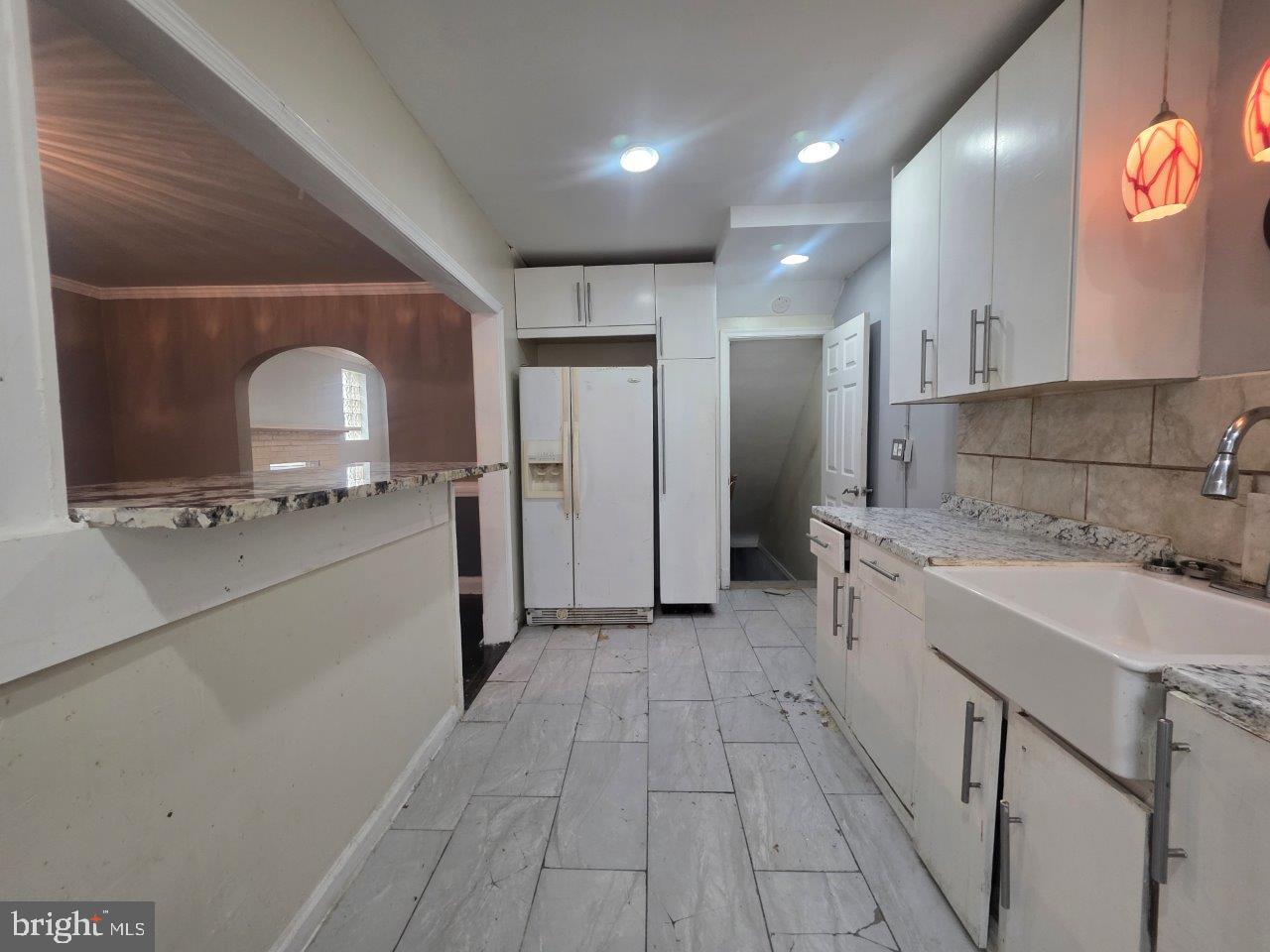 2211 Echodale Avenue Baltimore, MD 21214 - Photo 10 of 30 a kitchen with a sink and refrigerator