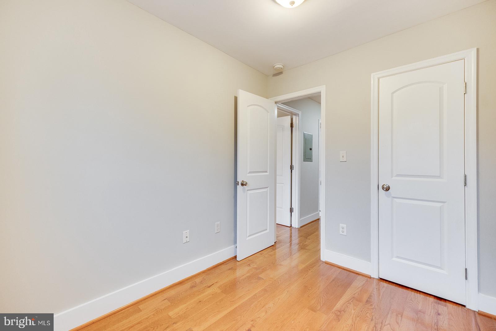 61 Forrester Street Southwest, Unit 104 Washington, DC 20032 - Photo 11 of 13 a view of an empty room with wooden floor
