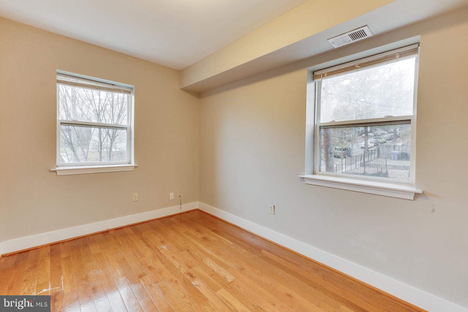61 Forrester Street Southwest, Unit 104 Washington, DC 20032 - Photo 2 of 13 a view of empty room with wooden floor and fan