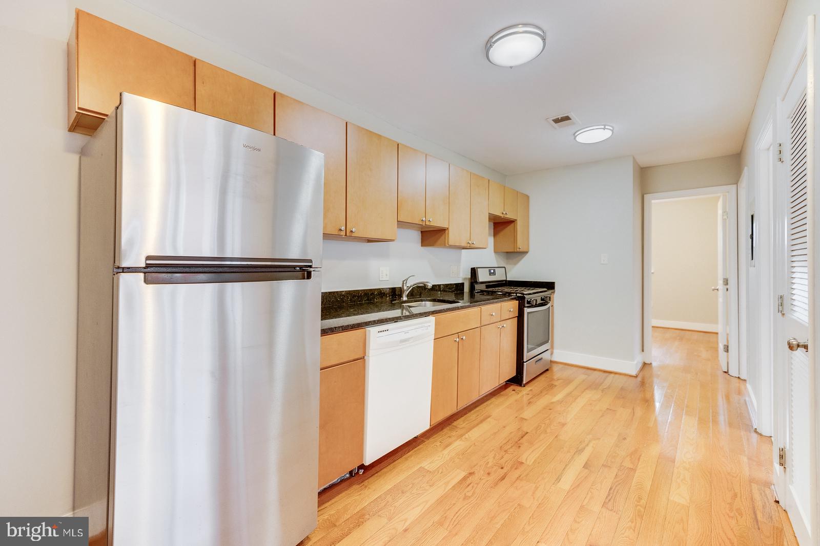 61 Forrester Street Southwest, Unit 104 Washington, DC 20032 - Photo 8 of 13 a kitchen with a refrigerator and a sink