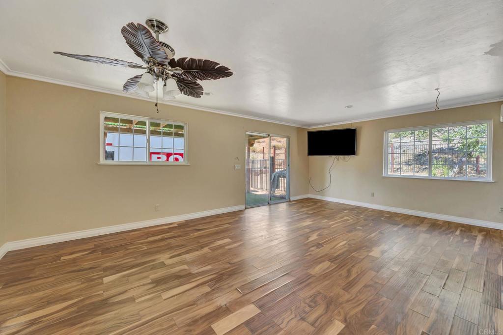 17620 Lyons Valley Road Jamul, CA 91935 - Photo 14 of 32 a view of empty room with wooden floor and fan