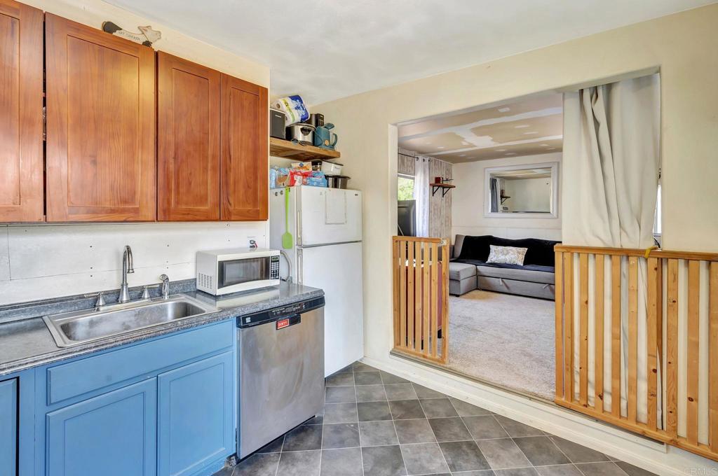 17620 Lyons Valley Road Jamul, CA 91935 - Photo 29 of 32 a kitchen with stainless steel appliances granite countertop a refrigerator and a sink