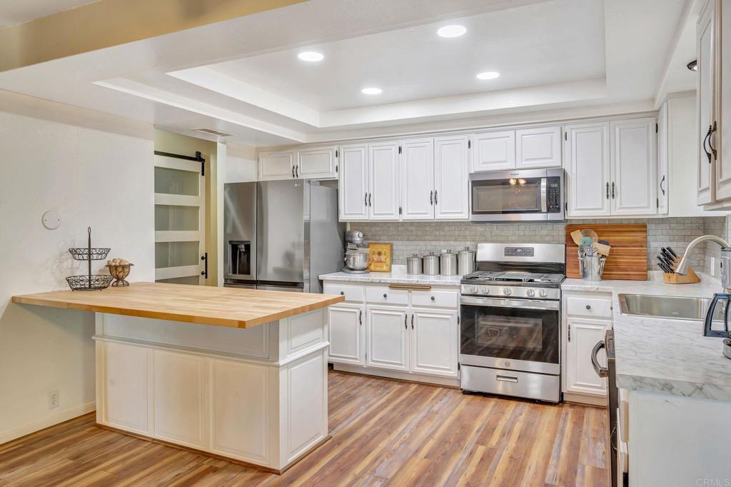 17620 Lyons Valley Road Jamul, CA 91935 - Photo 8 of 32 a kitchen with stainless steel appliances granite countertop a stove a sink and a refrigerator