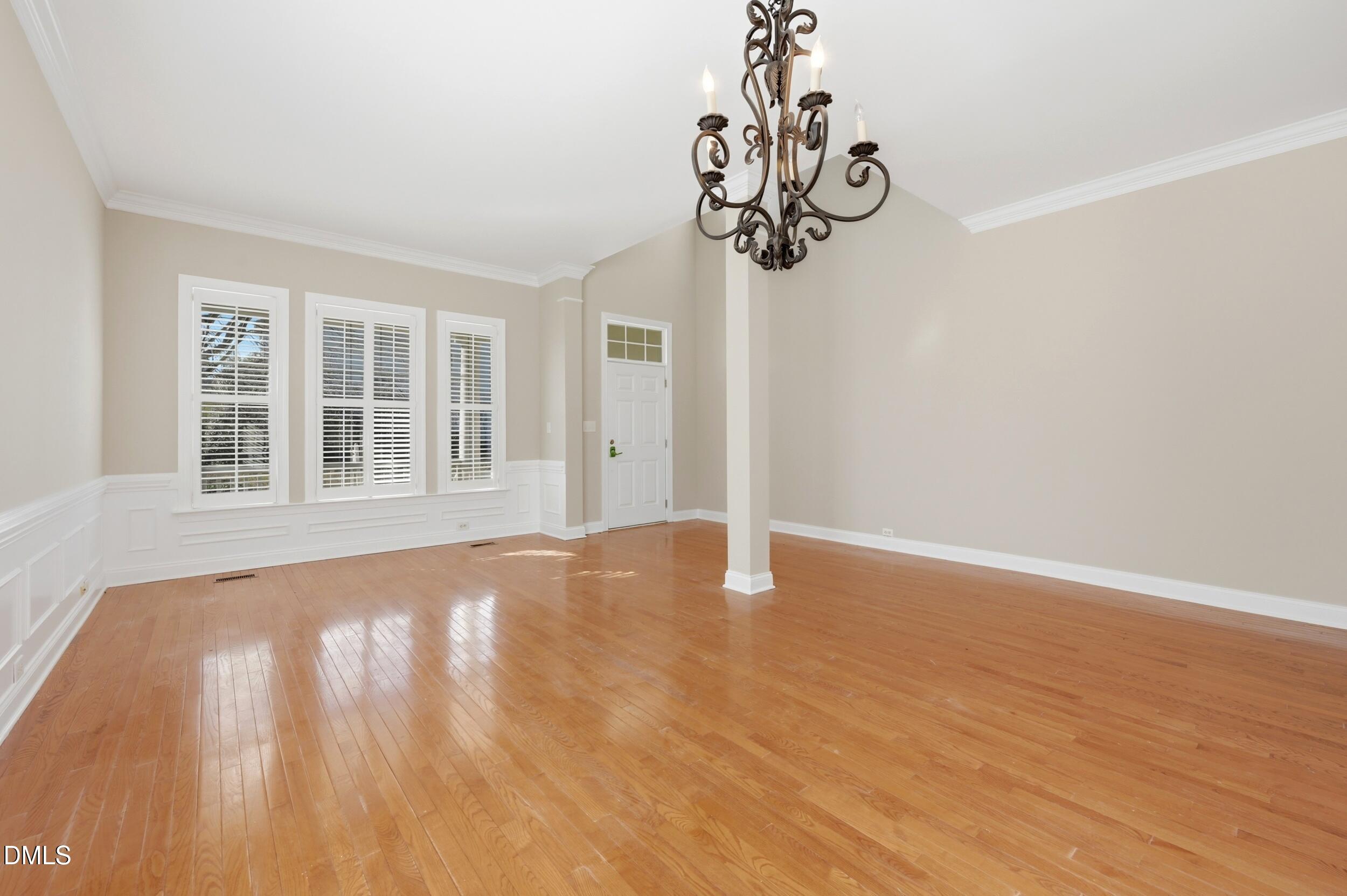 4803 Marena Place Durham, NC 27707 - Photo 5 of 42 a view of empty room with wooden floor and windows