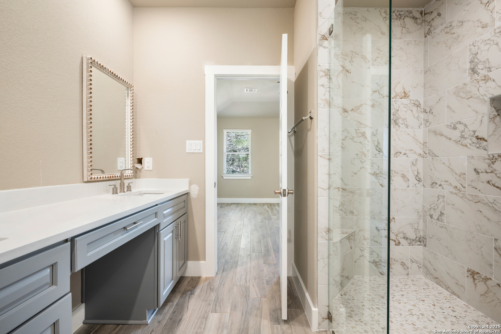1066 Primrose Path Spring Branch, TX 78070 - Photo 11 of 24 a bathroom with a granite countertop sink a mirror and a shower