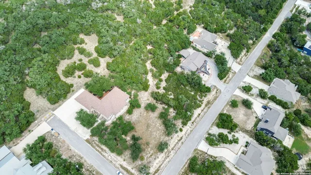 an aerial view of a house with a yard and garden