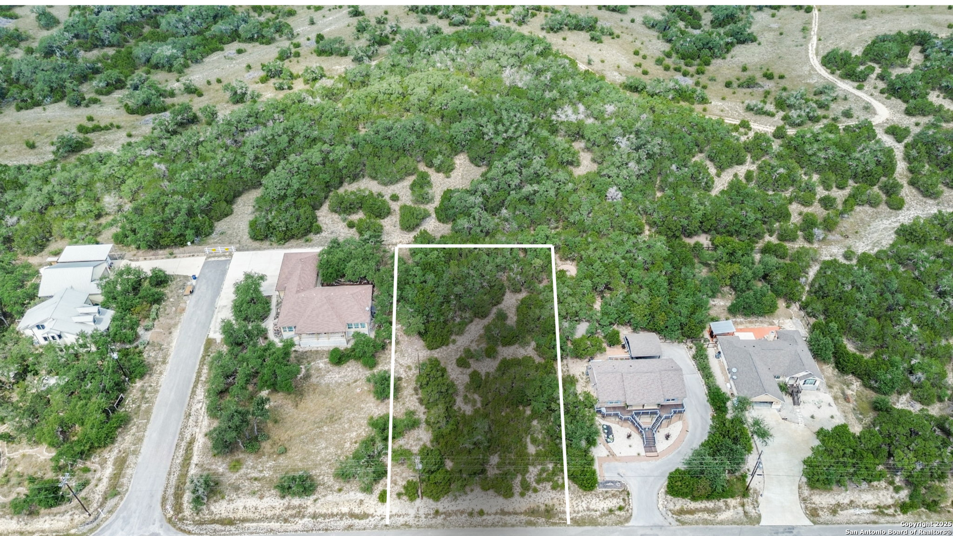 1066 Primrose Path Spring Branch, TX 78070 - Photo 2 of 24 an aerial view of a house with a yard and garden