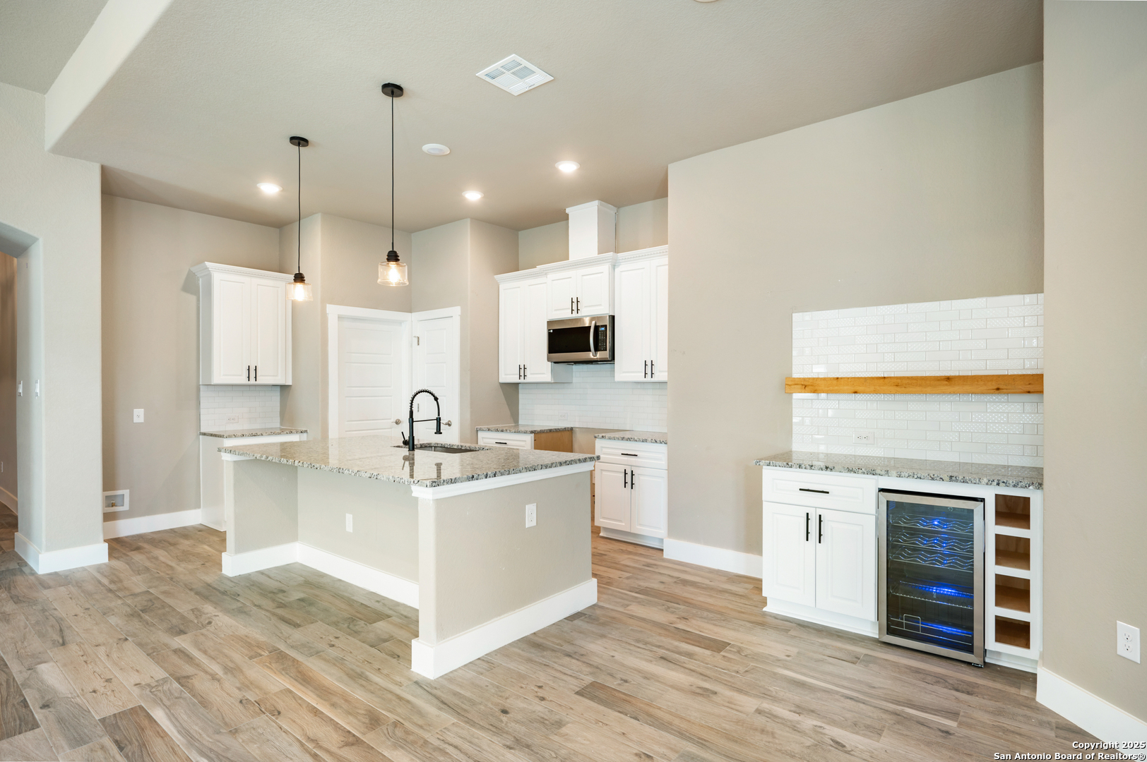 1066 Primrose Path Spring Branch, TX 78070 - Photo 5 of 24 a view of a kitchen with kitchen island a sink stainless steel appliances and cabinets