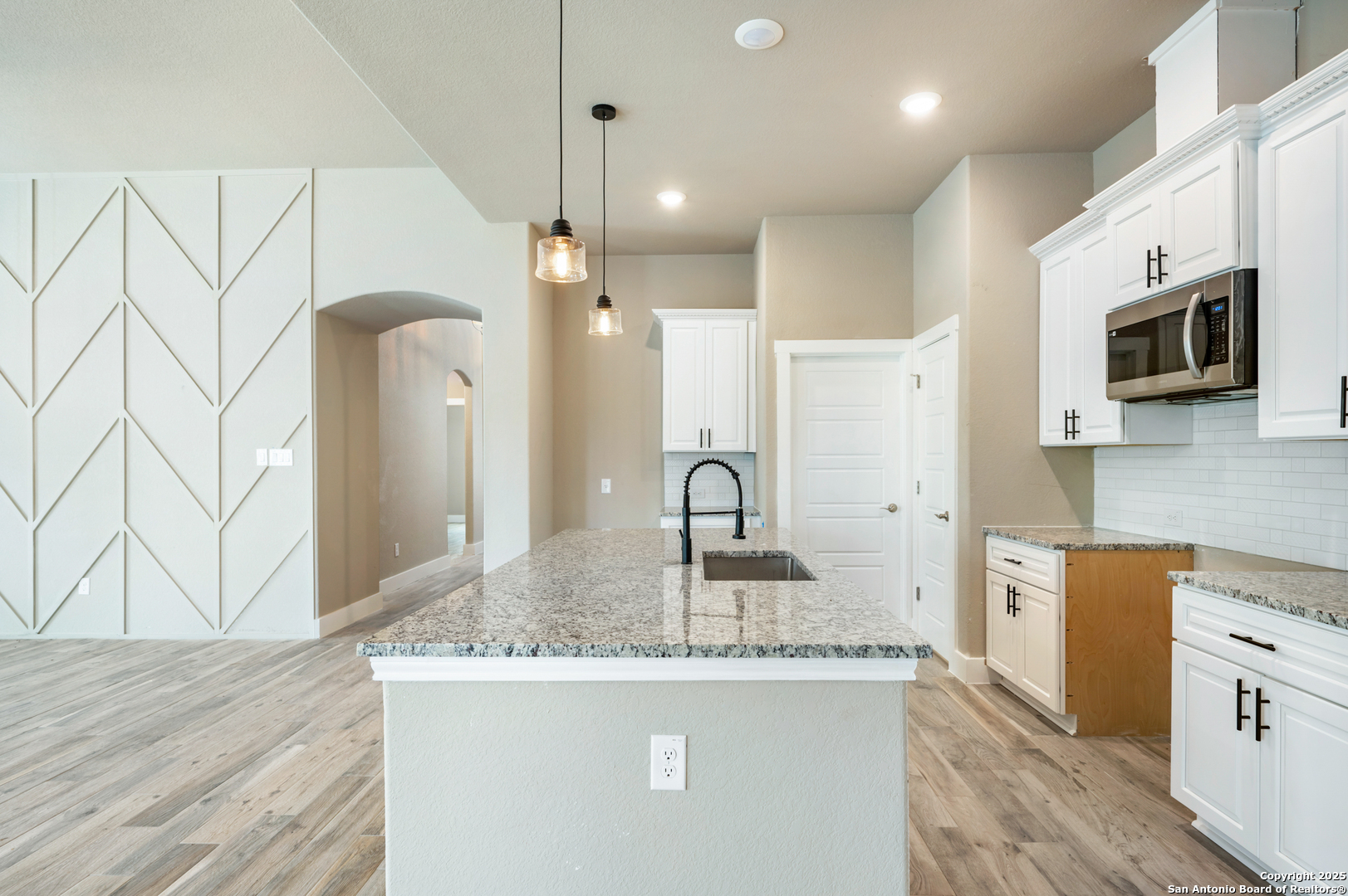 1066 Primrose Path Spring Branch, TX 78070 - Photo 6 of 24 a kitchen with kitchen island granite countertop a sink a stove and refrigerator