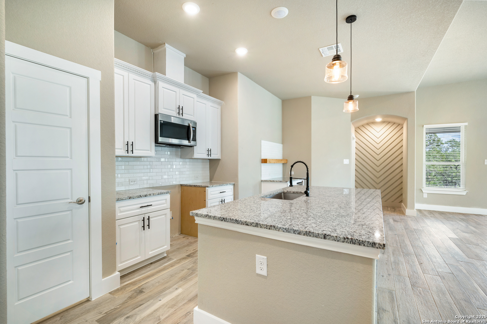 1066 Primrose Path Spring Branch, TX 78070 - Photo 9 of 24 a kitchen with granite countertop a sink a stove and a granite counter top