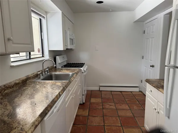 a kitchen with a sink a stove and cabinets