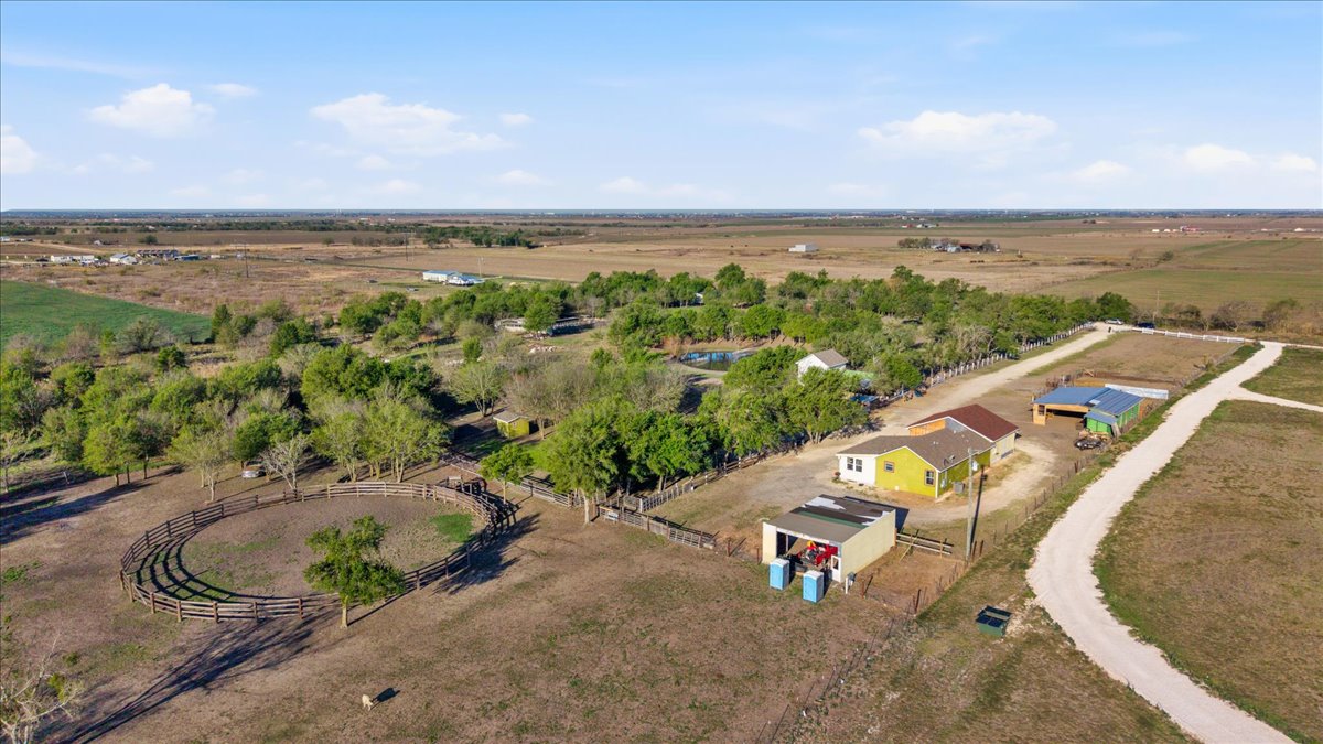 an aerial view of a house with a yard and lake view
