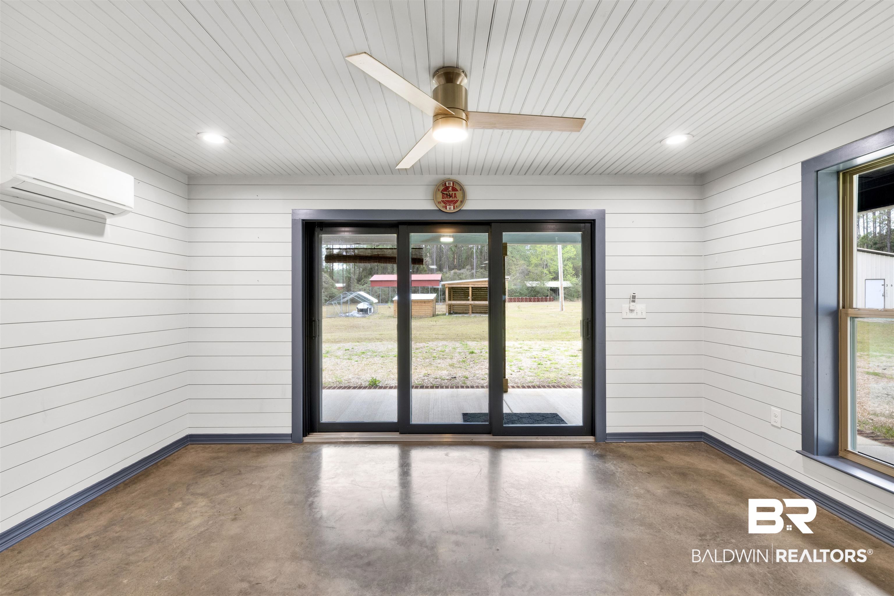 36397 Alexandria Trail Stapleton, AL 36578 - Photo 27 of 65 Spare room with concrete floors, plenty of natural light, a ceiling fan, wooden walls, and wood ceiling