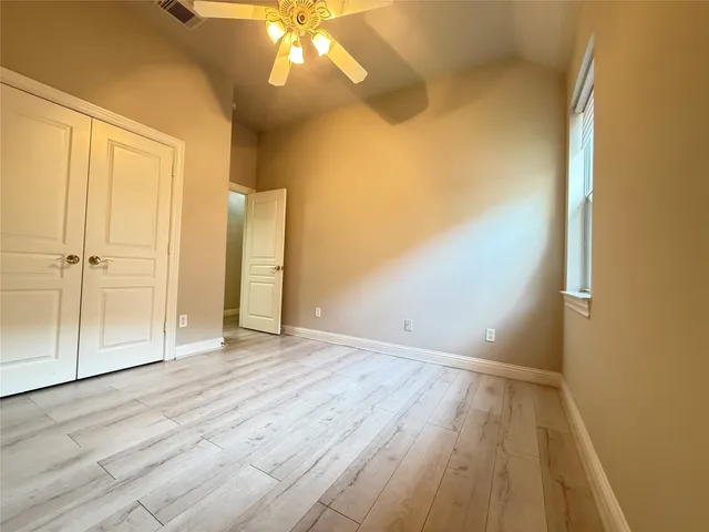 a spacious bathroom with a tub sink and mirror