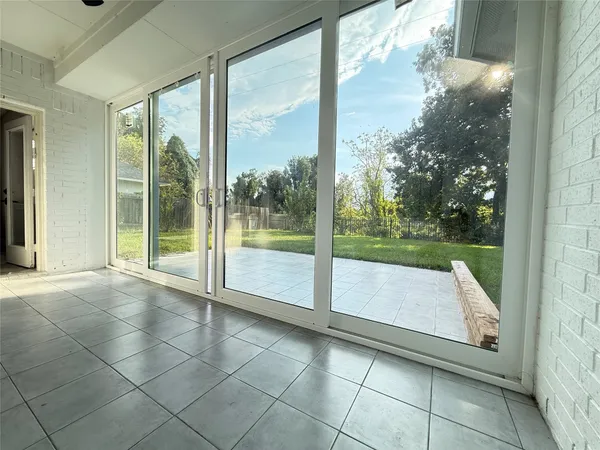a view of house with yard and glass windows