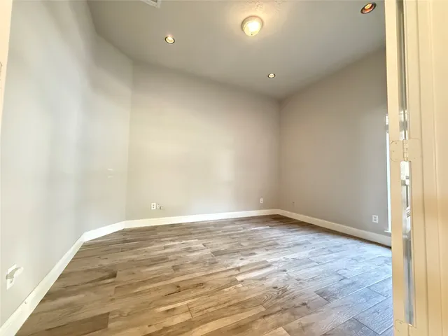 a kitchen with stainless steel appliances granite countertop a white refrigerator a sink dishwasher and wooden floor